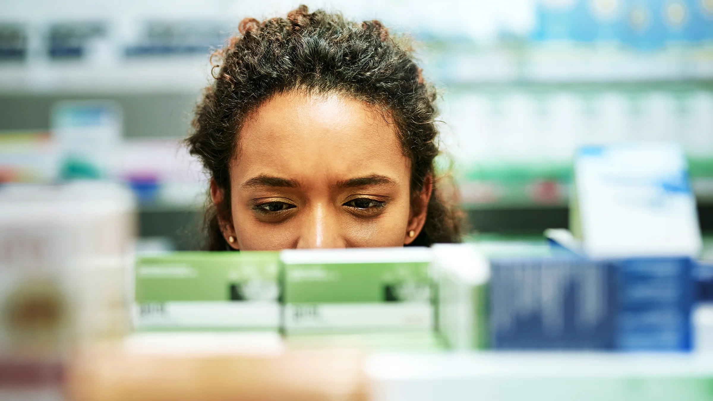 A woman browses the shelves of the pharmacy.