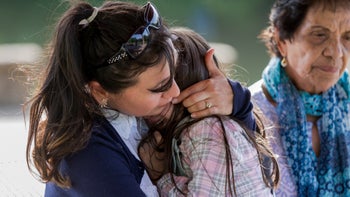 Anxiety: Age: child crying on parents lap with grandparent 1158890291