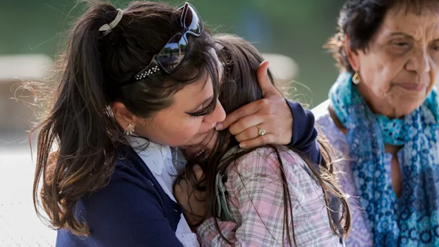 Anxiety: Age: child crying on parents lap with grandparent 1158890291