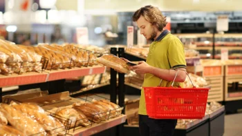 diet nutrition: looking up on phone bread aisle 1324895019