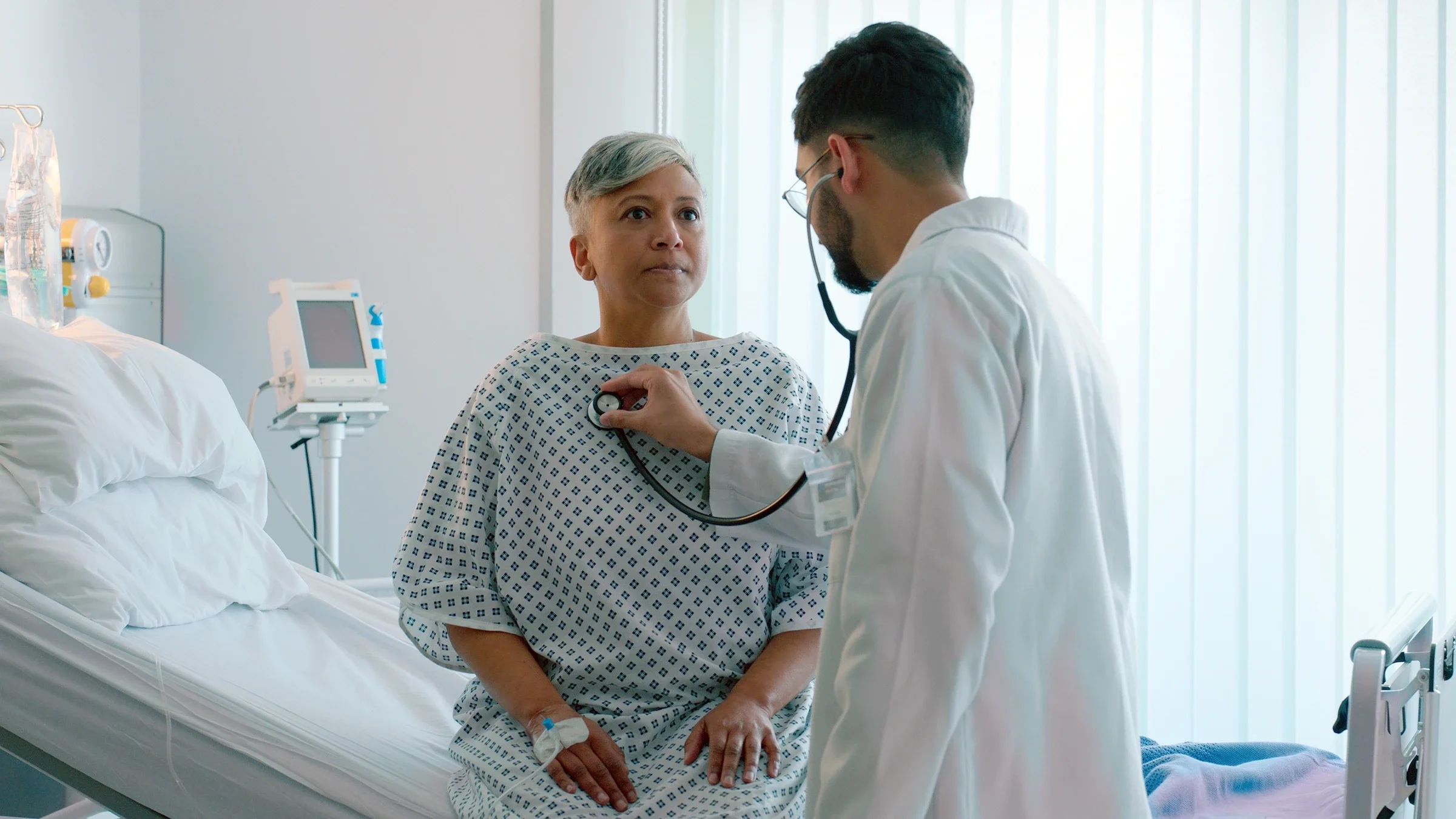 Doctor using stethoscope on patient.