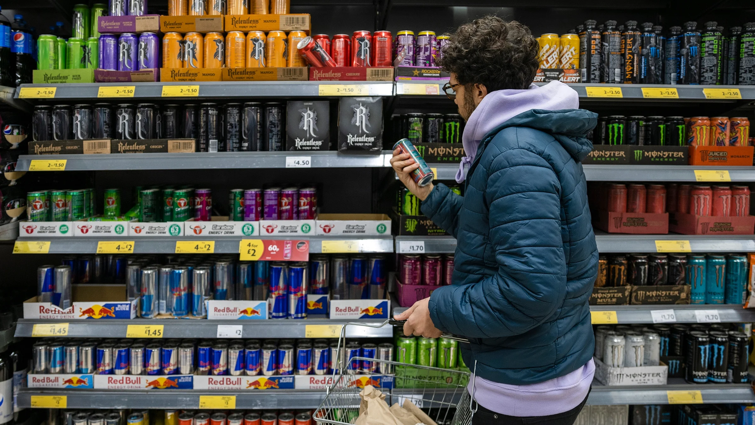 Man buying energy drink in the supermarket.