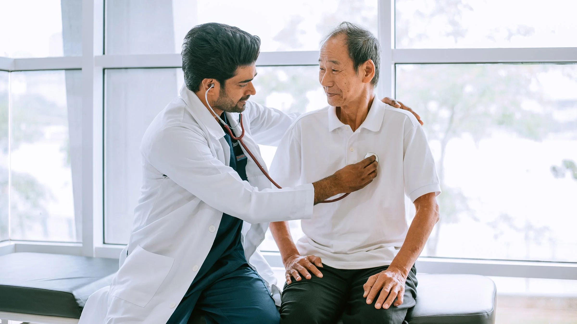 An older patient receiving a physical exam.
