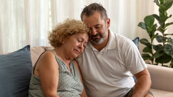 alzheimers-disease: man consoling senior mother 1476742815