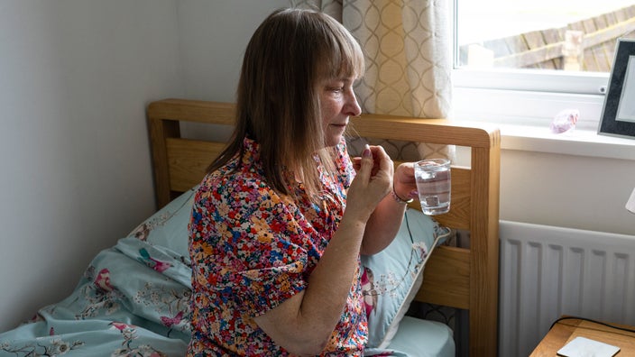 A person taking a pill.