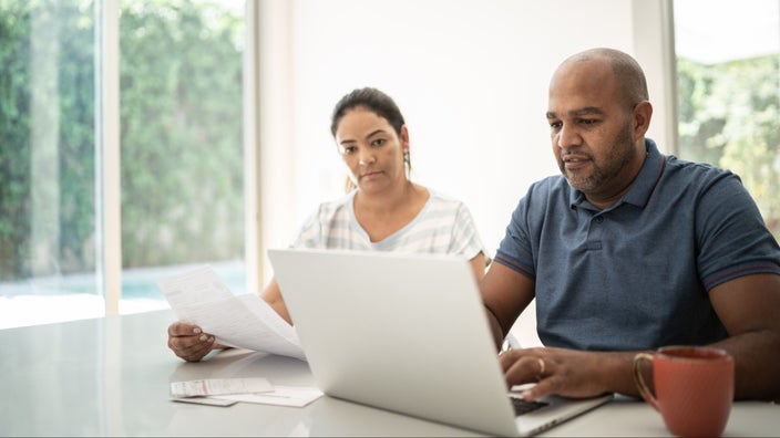 A couple does their finances at home.