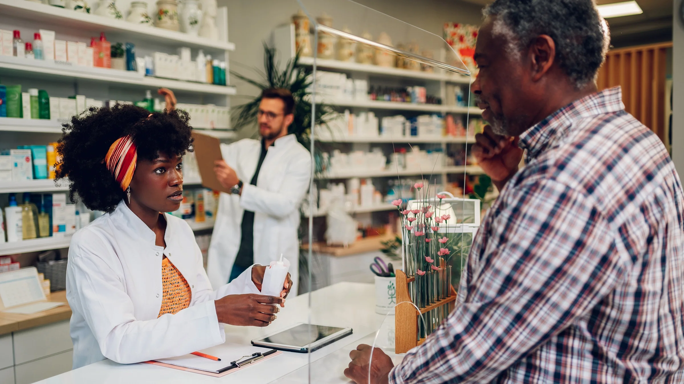 A pharmacist speaks to a customer.
