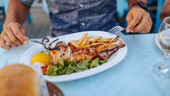 Health: Diet and nutrition: person eating healthy lunch outdoors-1341665361