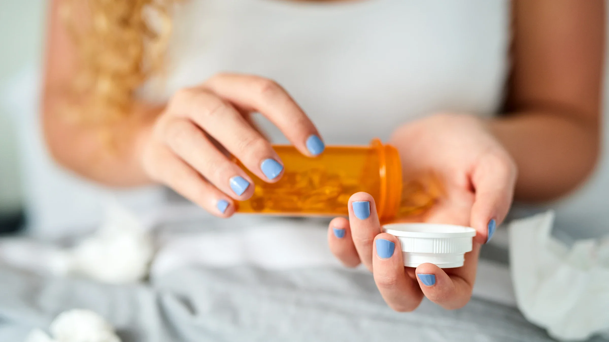Close-up of a person pouring medication from a pill bottle.
Charday Penn/E+ via Getty Images