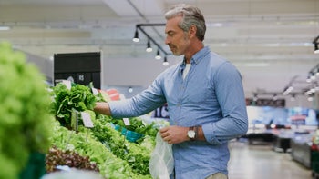 Health: gerd: man bying lettuce at grocery store 951088422