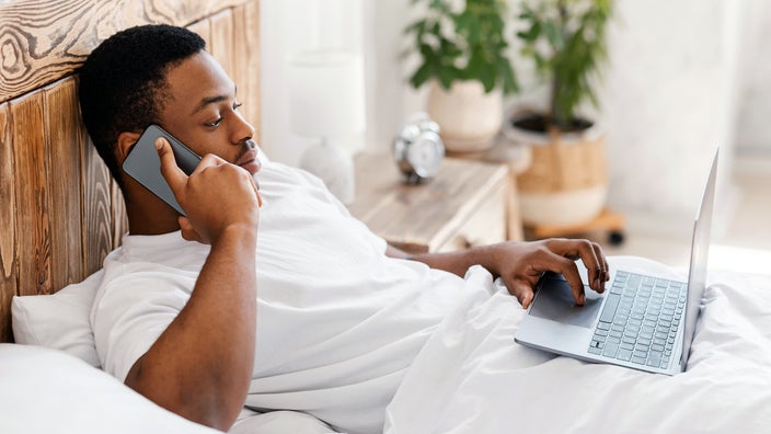A man is searching on his computer for where to get a test for the flu.