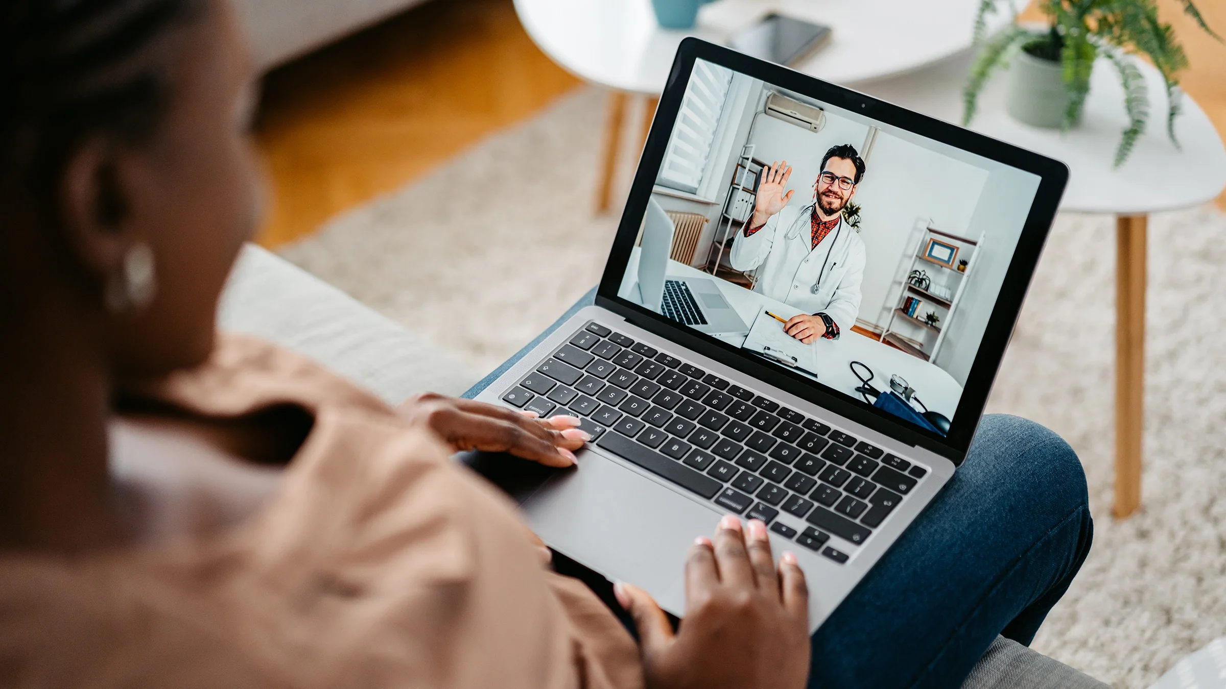 A woman has a telehealth call with a medical professional.