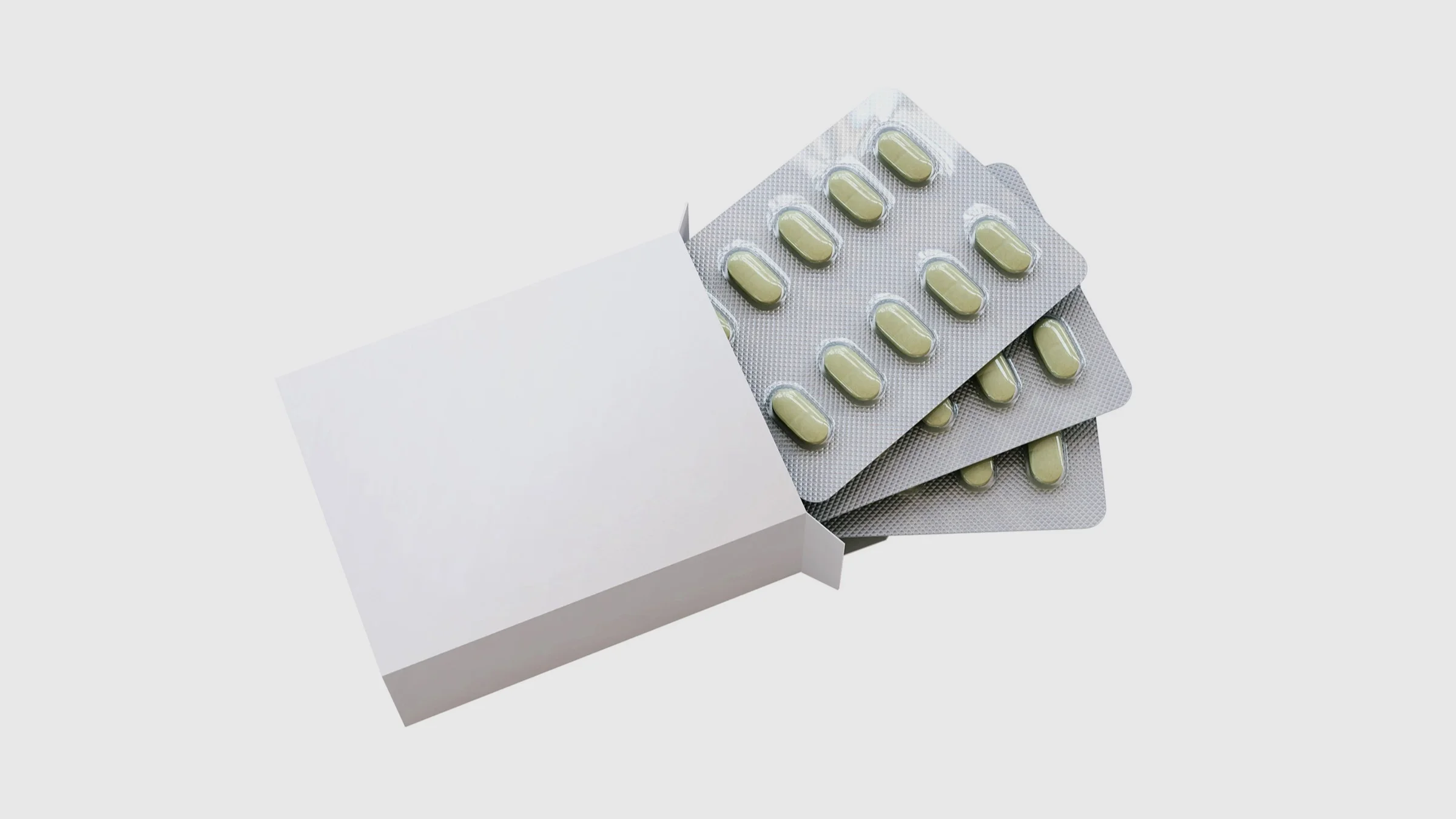 White box filled with blister packs of white pills on a white background.