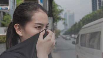 Respiratory: Pollution: covering nose with shirt polluted city-1136099546