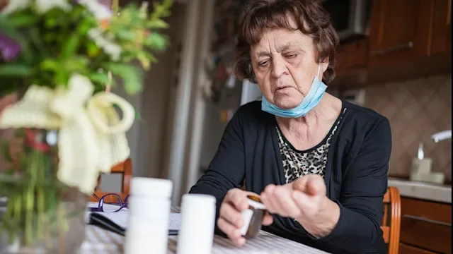 depression: medication: pills: senior woman taking medication 1244729722