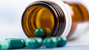 Keflex: green capsules spilling out of bottle 637075536