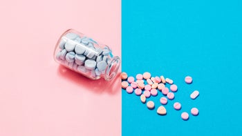 Senior health: pills on blue and pink background 1278493860