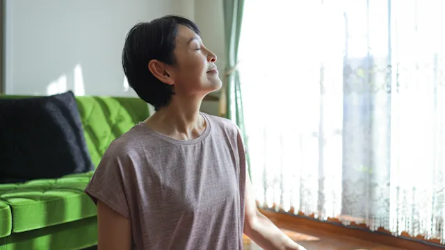 Alternative treatments: woman feeling the sun shine on her face 1752179225