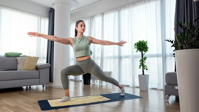 Health: Patient experiences: woman practicing yoga at home 1428036717