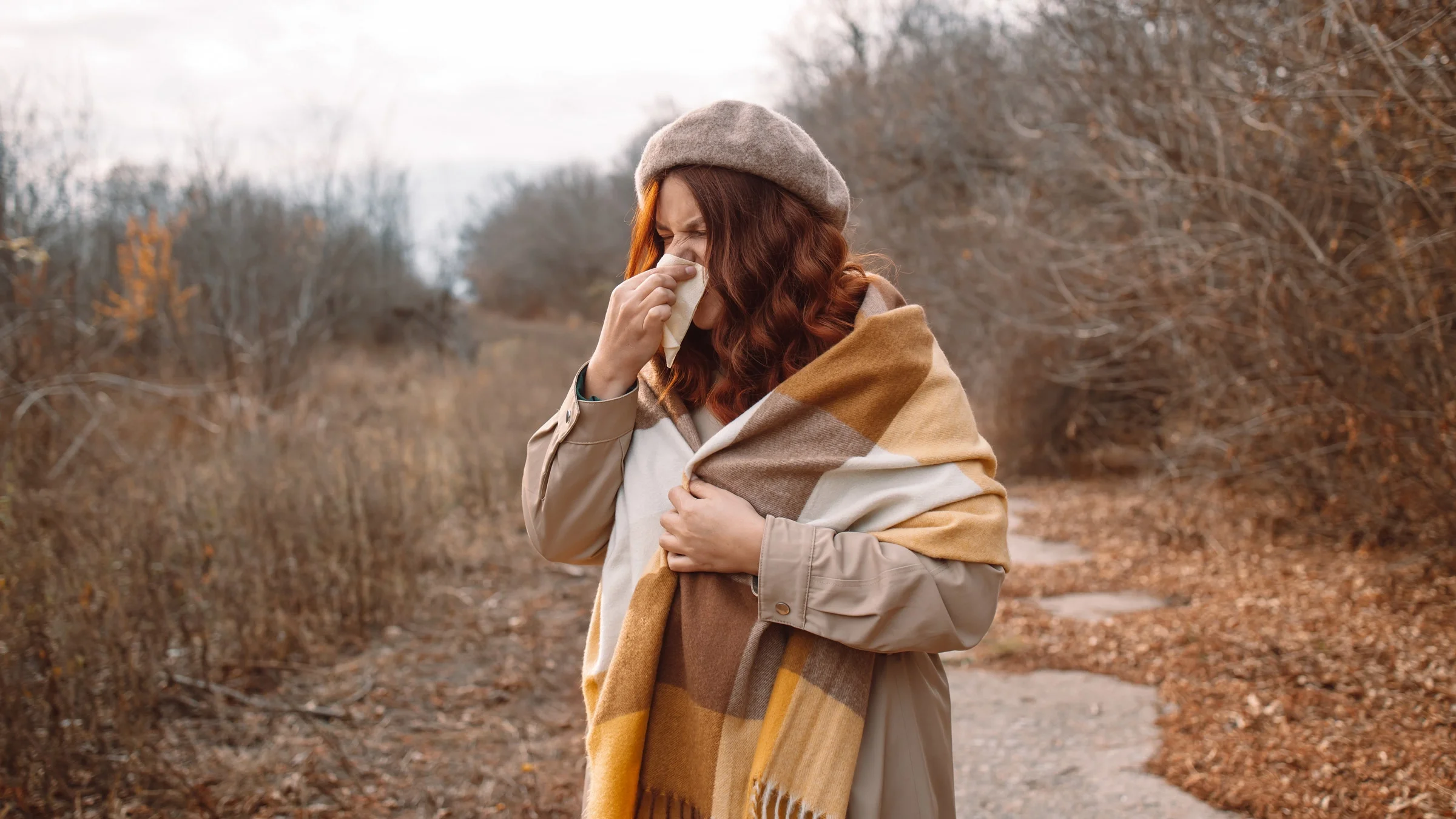 A person with allergies blowing their nose.