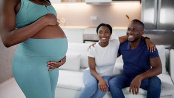 Pregnant: Surrogacy: couple smiling pregnant surrogate 1572514036