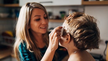 Health: Skin infection: mother applying ointment to son 1423288407