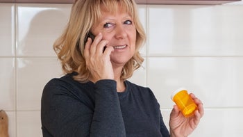 Metformin: phone call holding pill bottle 1130152177