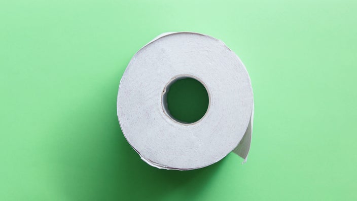 Roll of toilet paper on a light green background.