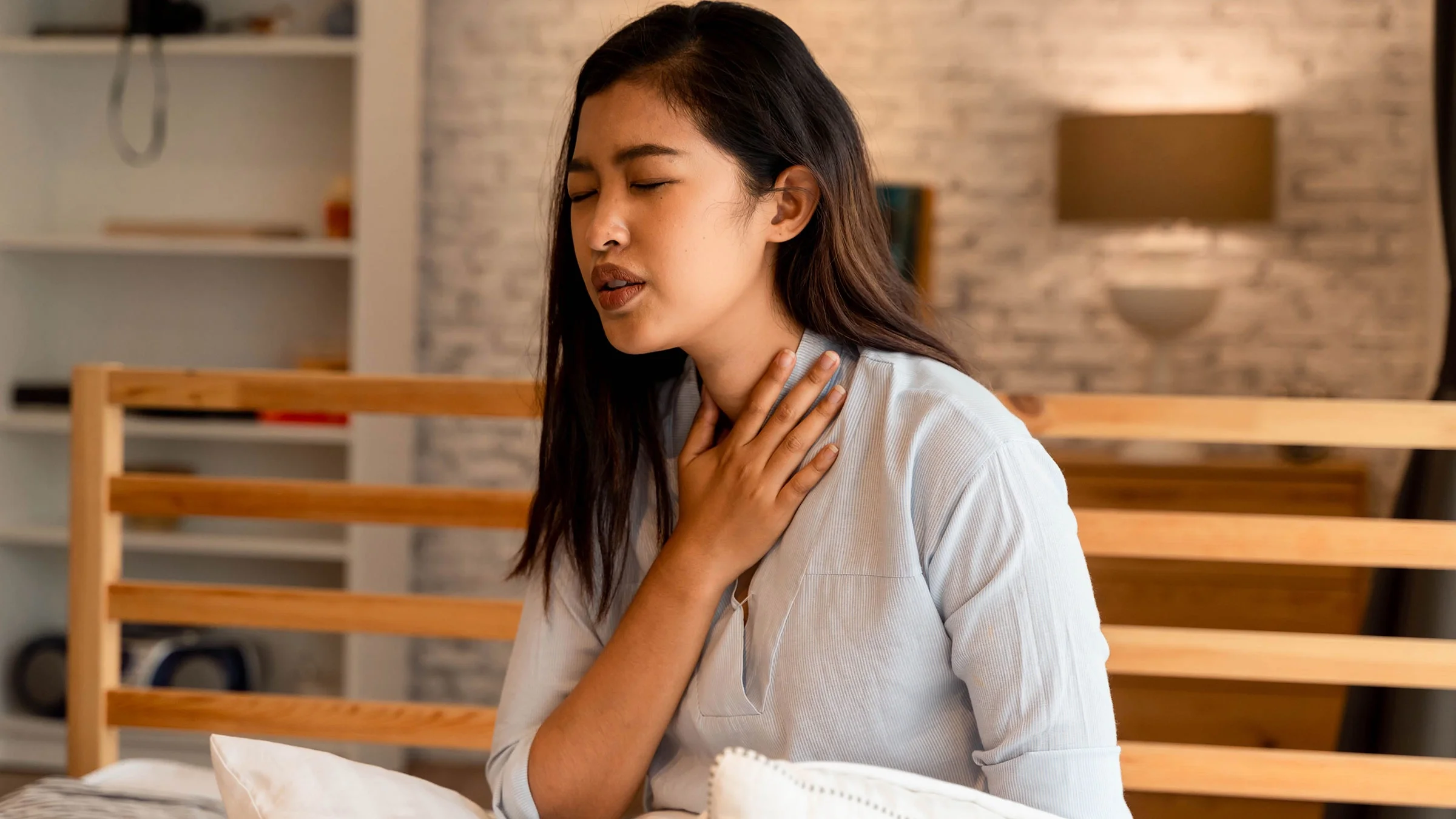 A woman is having trouble breathing at home.