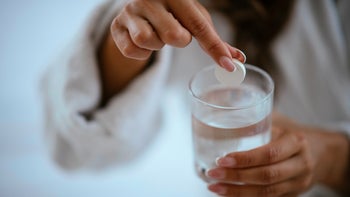 gerd: closeup woman antacid water 1043980730