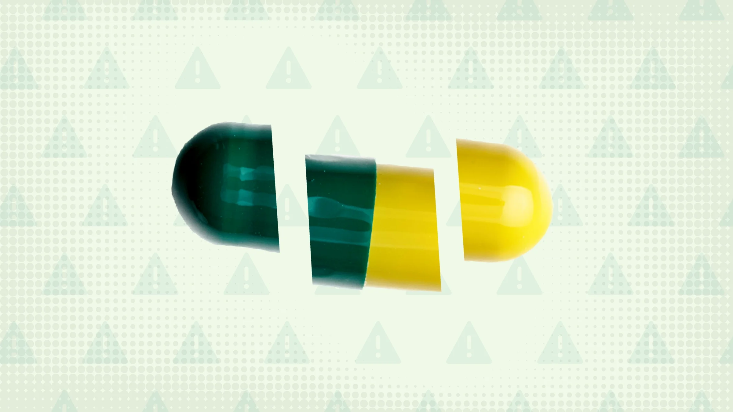 Light green background with texture and warning sign pattern. In the center is a green and yellow capsule pill cut into thirds.