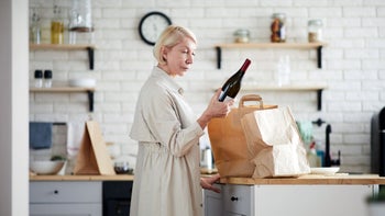 Health: Methotrexate: woman reading wine label 1139901443