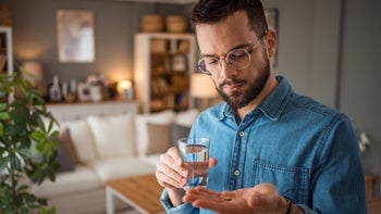 Personal Finance: Pharmacy: man takes medication 2025715909