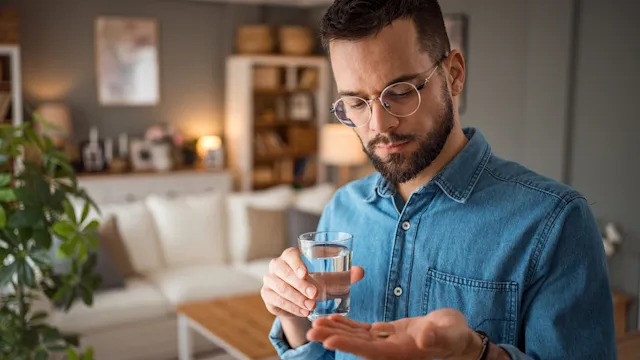 Personal Finance: Pharmacy: man takes medication 2025715909