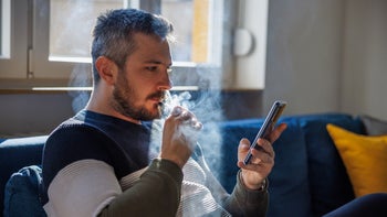 Smoking cessation: man smoking electronic cigarette 1418983675