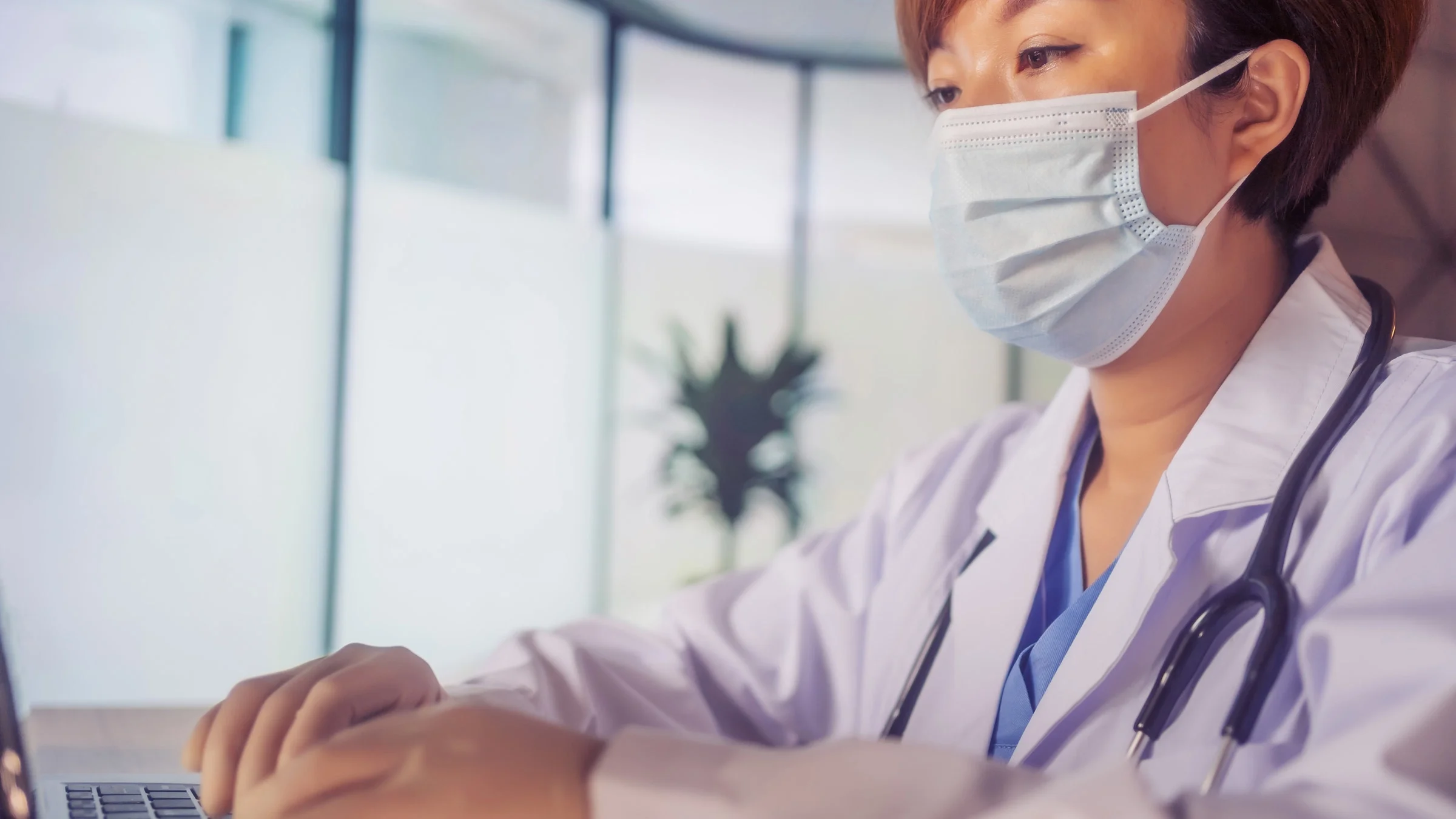 A docor using a laptop.