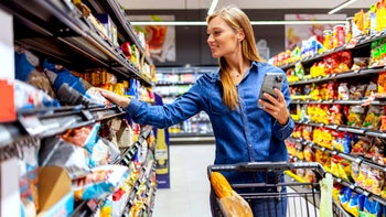 diet nutrition: snack aisle using phone 1396834763