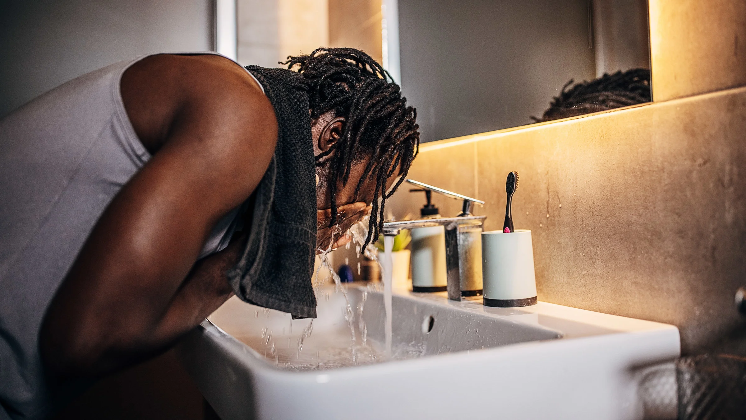 A person washing their face.