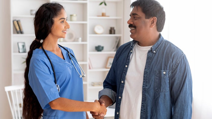 A patient shaking hands with their doctor.