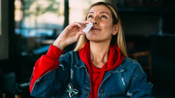 Nicotrol: woman using nasal spray 1185089905