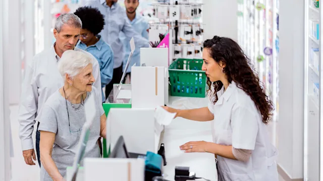 Medicare: Drug coverage: senior customer talking to pharmacist 1193113996