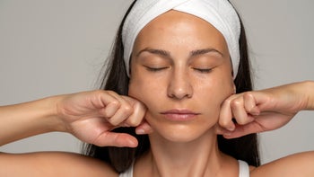 Dermatology: woman massaging face 1348105461