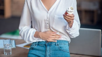 Side effects: holding pill bottle stomachache 1192610647
