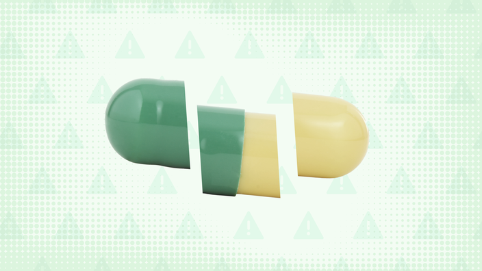 In the center, against a light green background with texture and warning signs, is a green and yellow capsule pill cut into thirds.