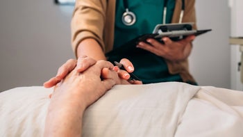 Providers: nurse holding patients hand-1219136359