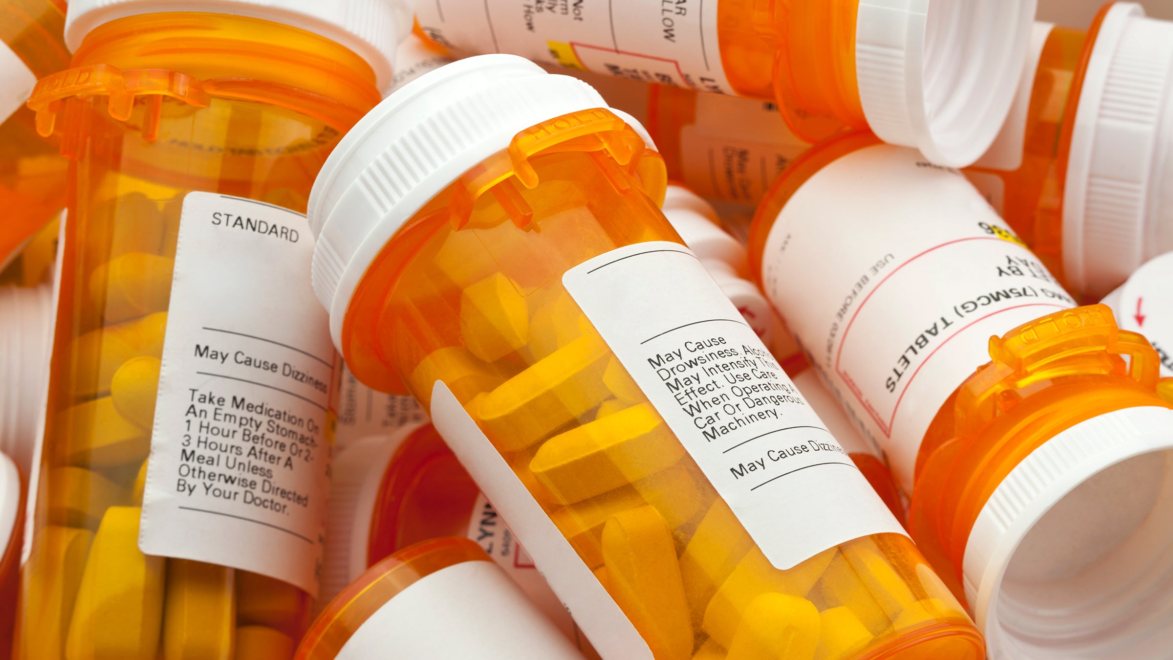 Research: pile of prescription bottles 166022271