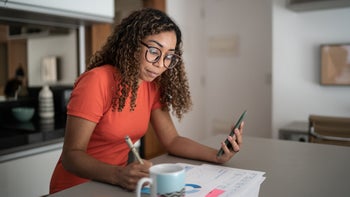 Black-health: woman doing finances at home 1314803948