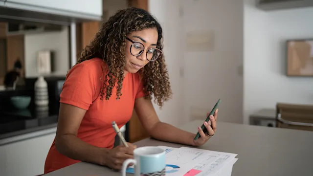 Black-health: woman doing finances at home 1314803948