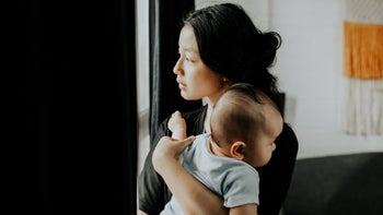 Depression: Post-partum medications: carrying baby looking outside 1314524633