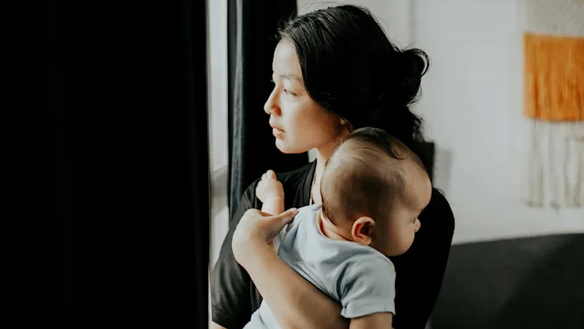Depression: Post-partum medications: carrying baby looking outside 1314524633